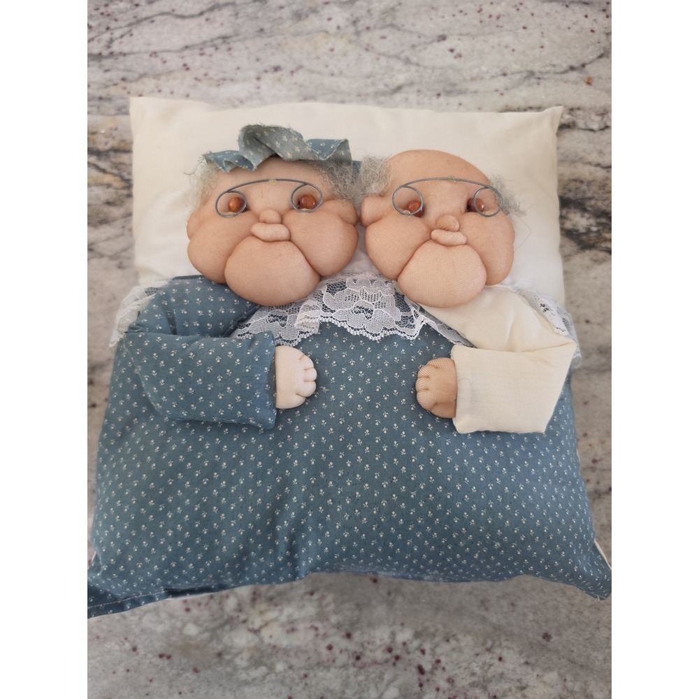 vintage, handcrafted soft-sculpture pillow featuring female and male adults